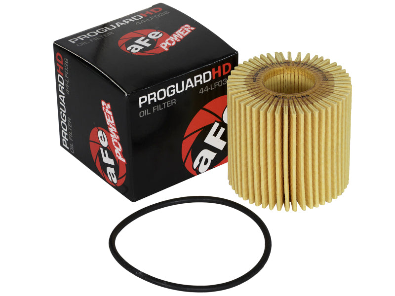 aFe PROGUARD oil filter with a round, pleated design next to its packaging and an O-ring for installation.