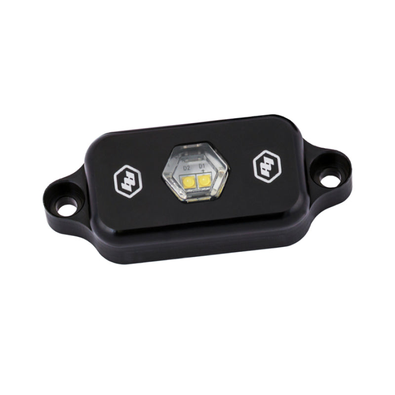 Baja Designs LED Rock Light in clear, featuring a compact design for enhanced visibility and rugged durability.