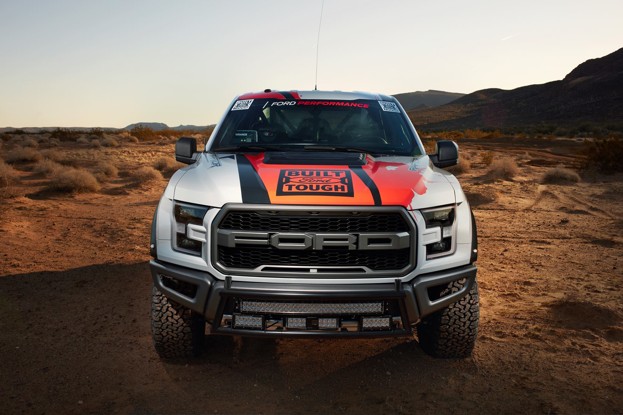 Front view of a 2017-2020 Ford Raptor showcasing a race truck bumper with a light bar mount kit installed.