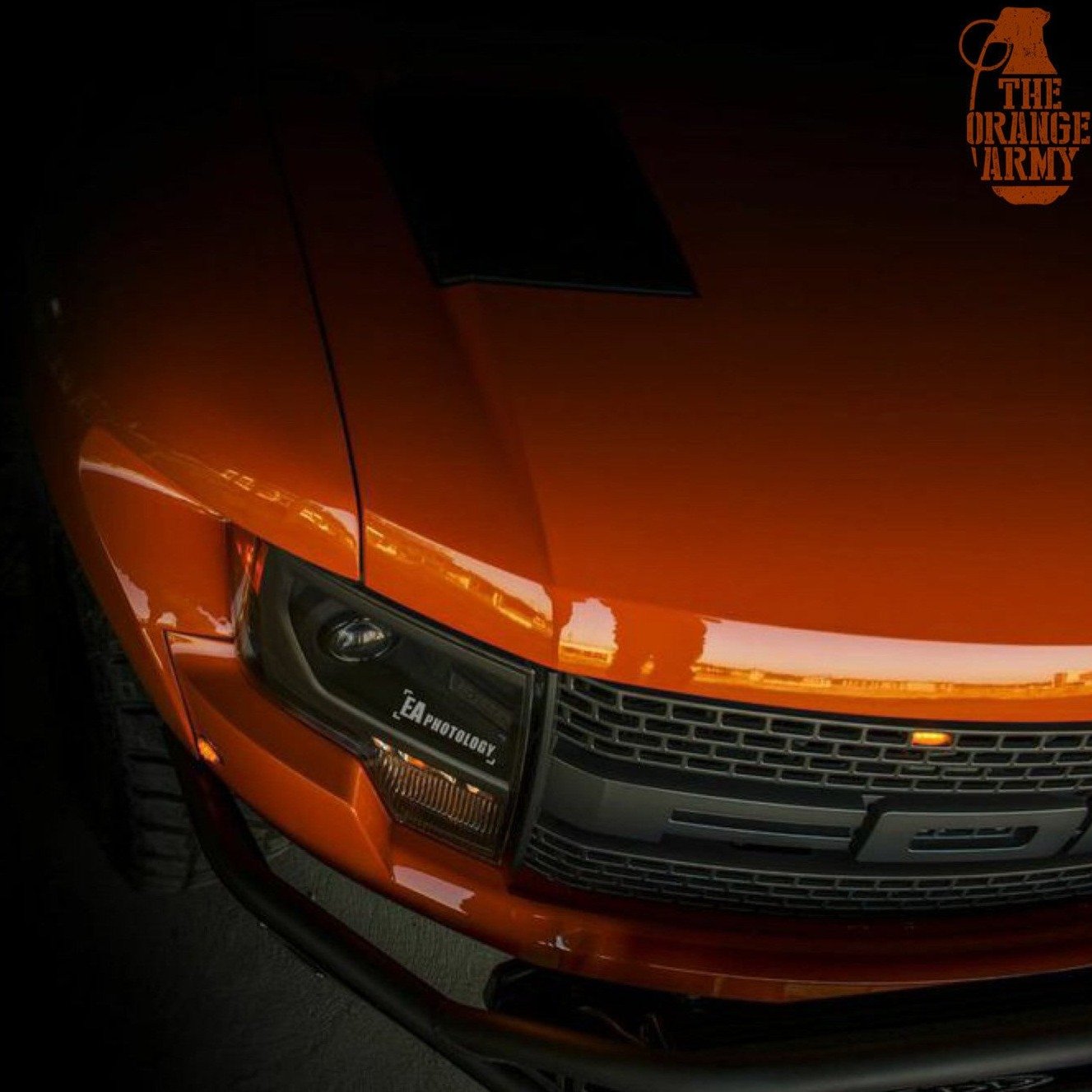 2010-2016 Ford Raptor fenders showcasing a sleek orange finish and aggressive styling for enhanced offroad performance.