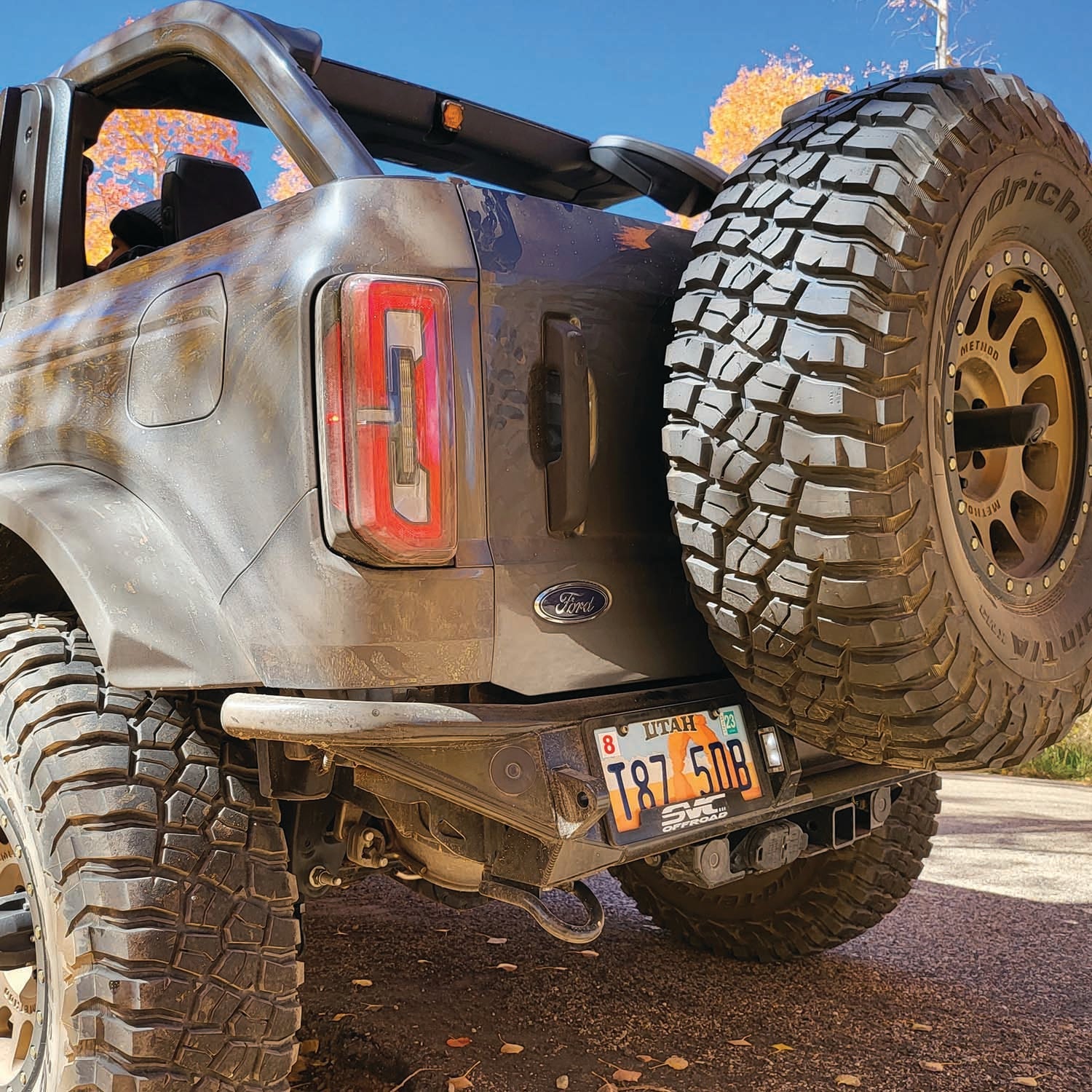 2021 Ford Bronco with Baja rear bumper showcasing rugged design and oversized tires for offroad performance.