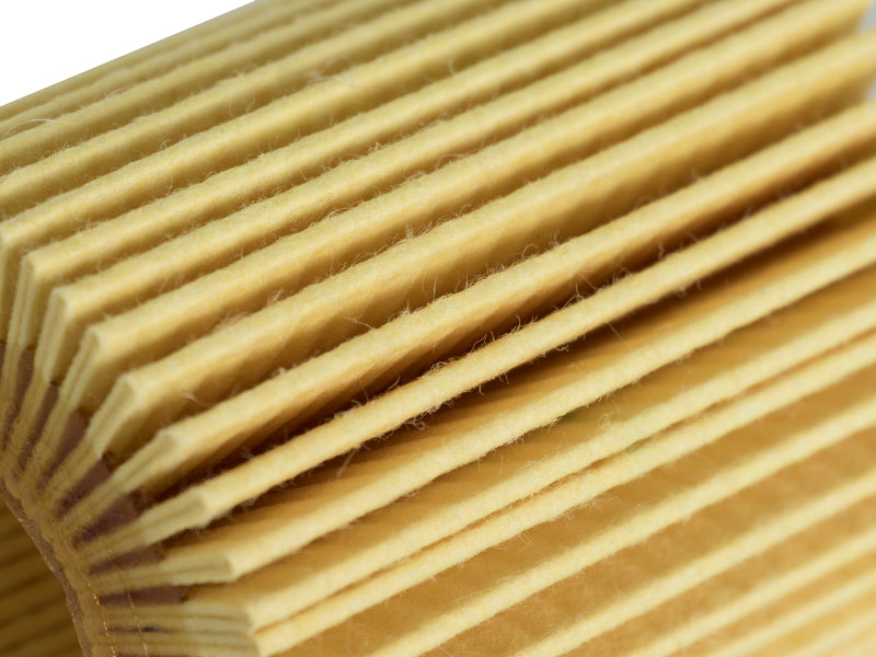 Close-up of the aFe ProGuard oil filter, showcasing its pleated design for effective filtration in vehicles.