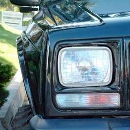 Close-up of a 1986-1992 Jeep Comanche fender showcasing its sleek design and integrated headlight.