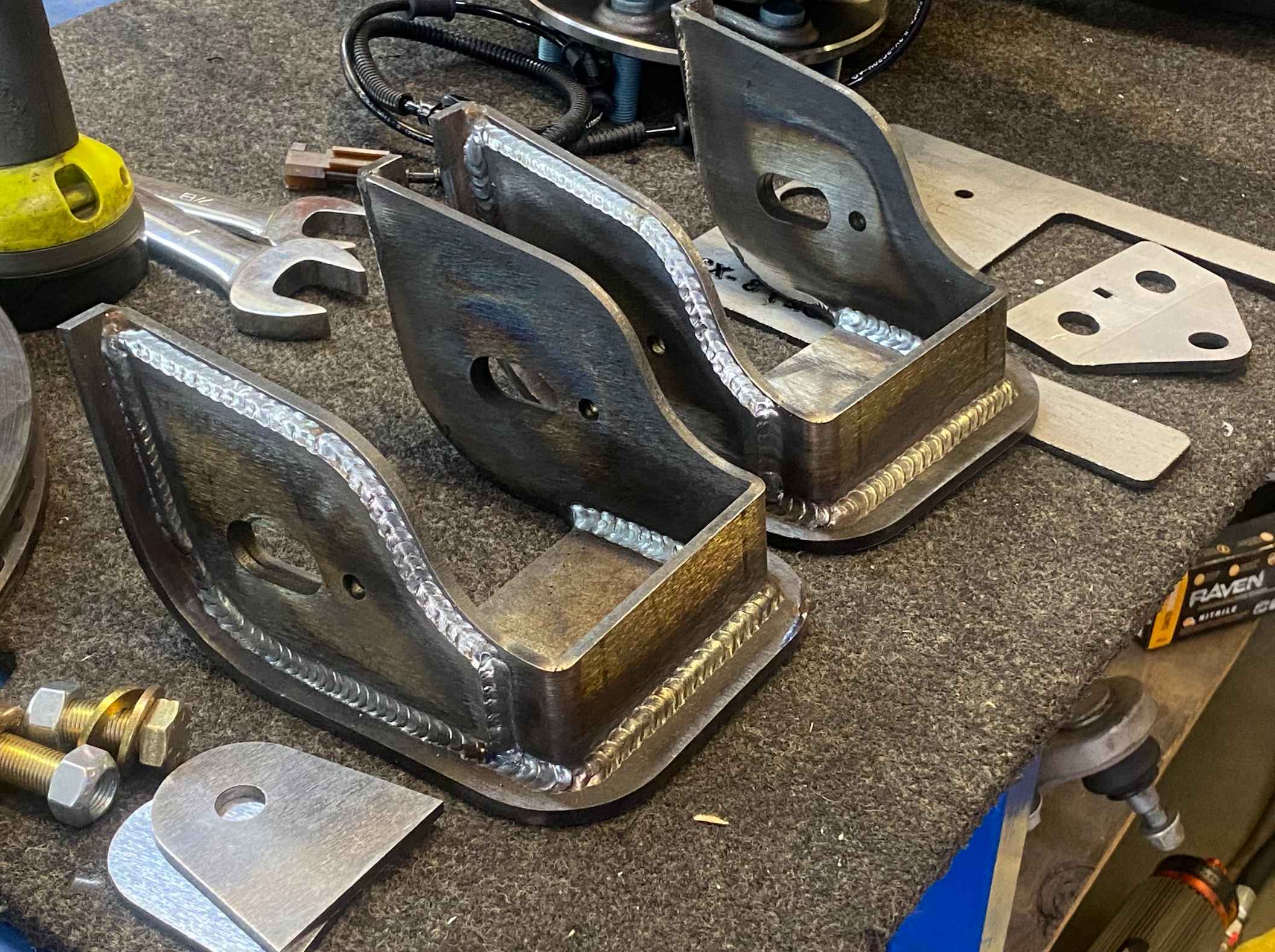 Lower arm pocket replacement kit for 2017-2024 Raptor by Foutz Motorsports, featuring welded metal components on a workbench.