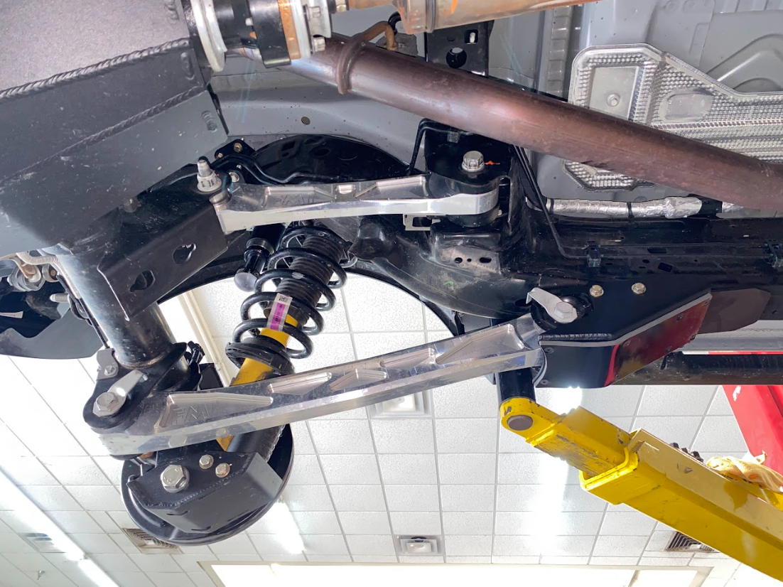 2021 and up Bronco rear lower arm frame guard with HDPE slide installed, showcasing suspension components and protective features.