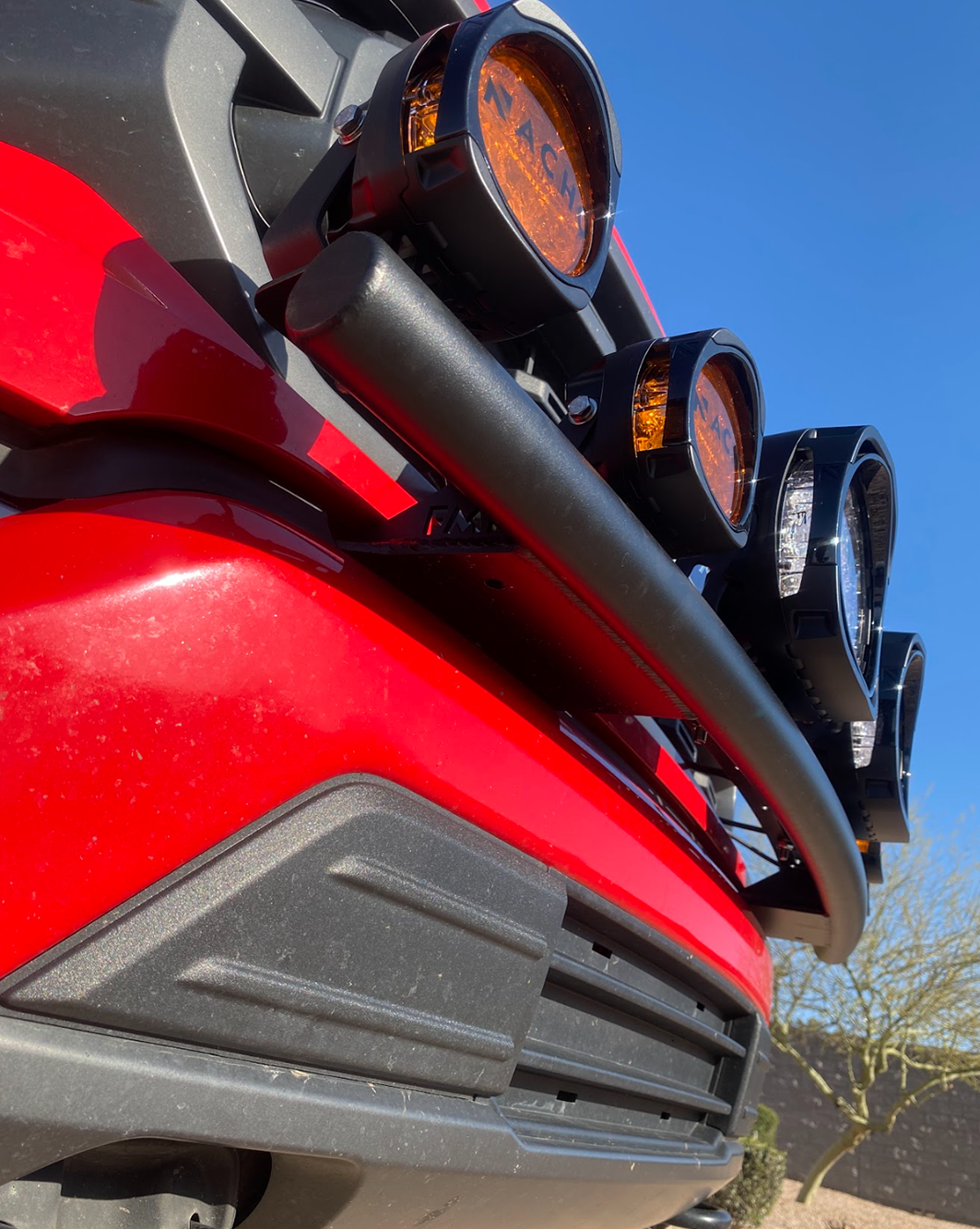Front light mount for 2021-2023 Ford F150, designed for stock bumper, showcasing multiple mounted lights on a red truck.