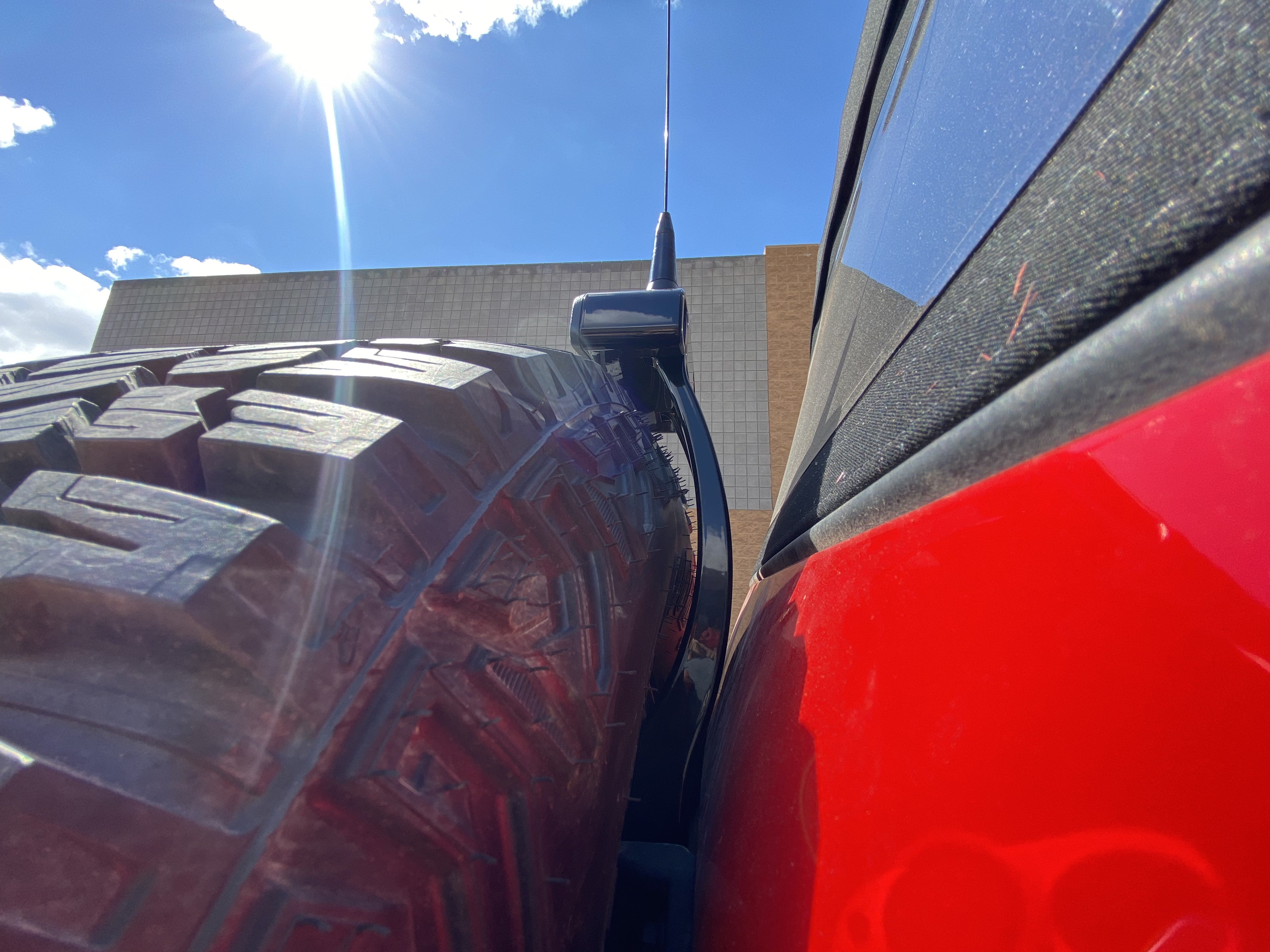 2021-25 Ford Bronco third brake light antenna mount installed next to a large tire, showcasing durability and functionality.