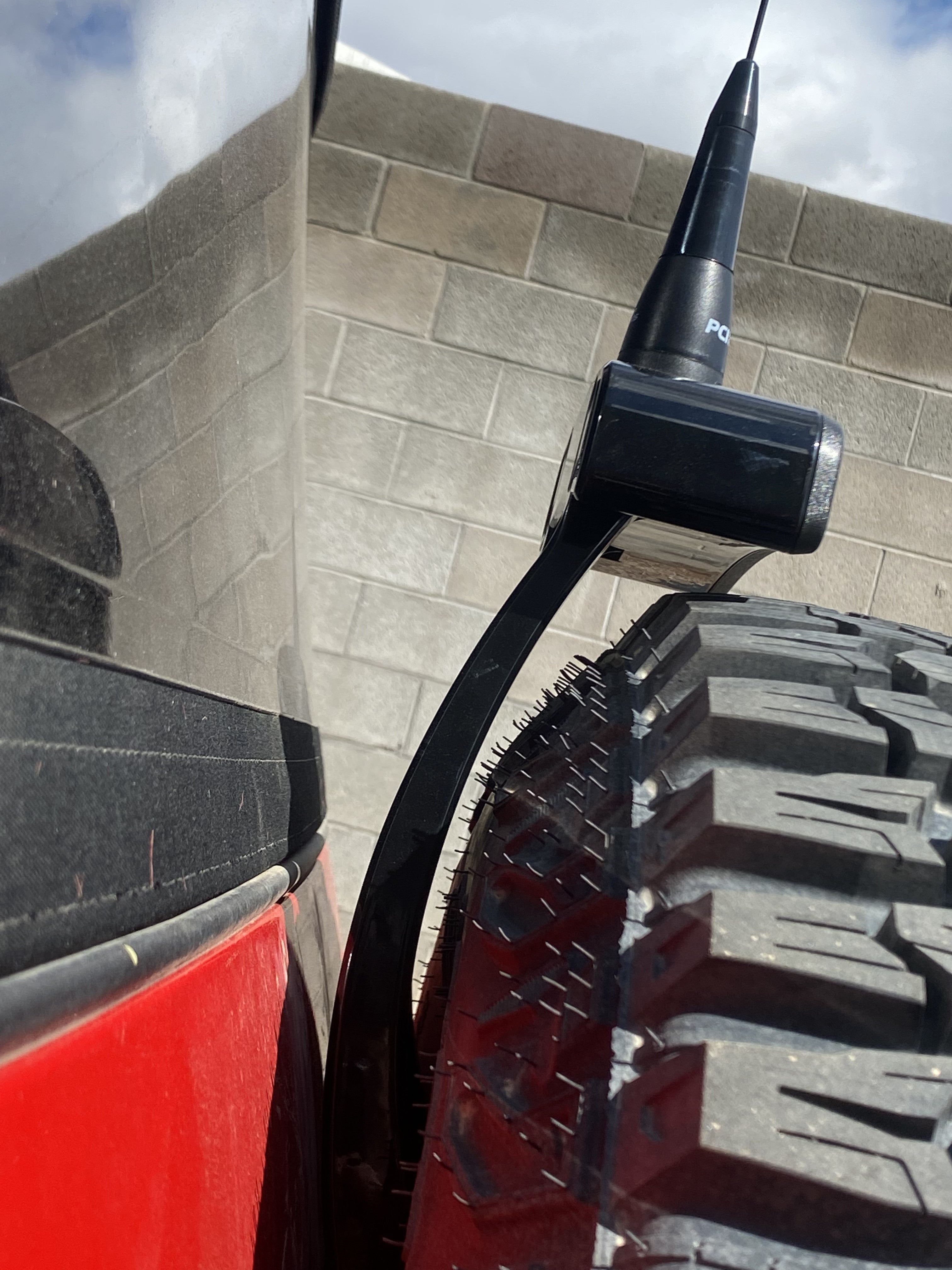 2021-25 Ford Bronco third brake light antenna mount installed on a vehicle with a large tire, showcasing durability and design.
