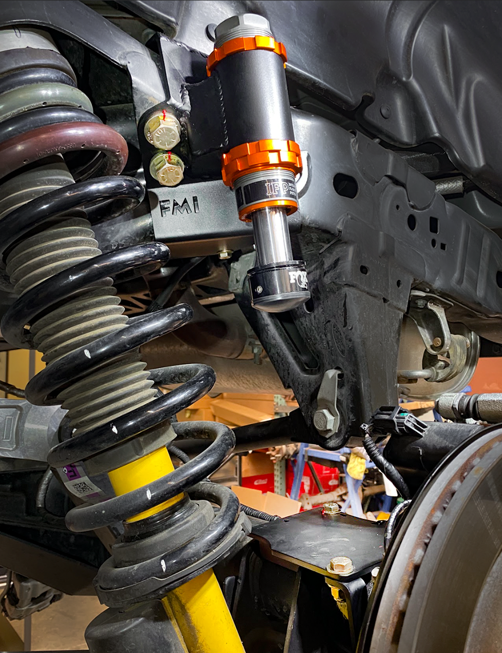 Adjustable rear bump stop kit installed on a 2021 Bronco, showcasing suspension components and mounting details.
