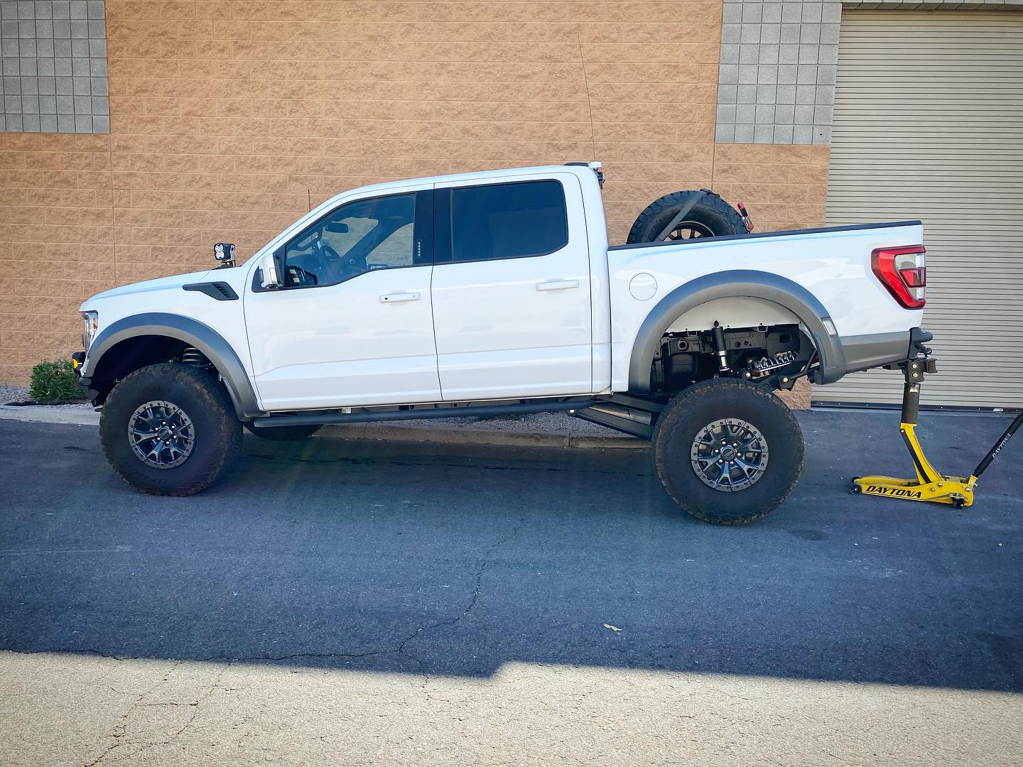 2021-2024 Raptor Long Travel Rear Suspension Kit showcasing a lifted Gen 3 Raptor with 19 inches of travel.
