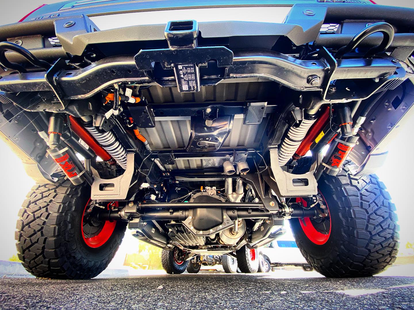 2021-2024 Raptor Long Travel Rear Suspension Kit showcasing 19 inches of travel, installed under a lifted truck.