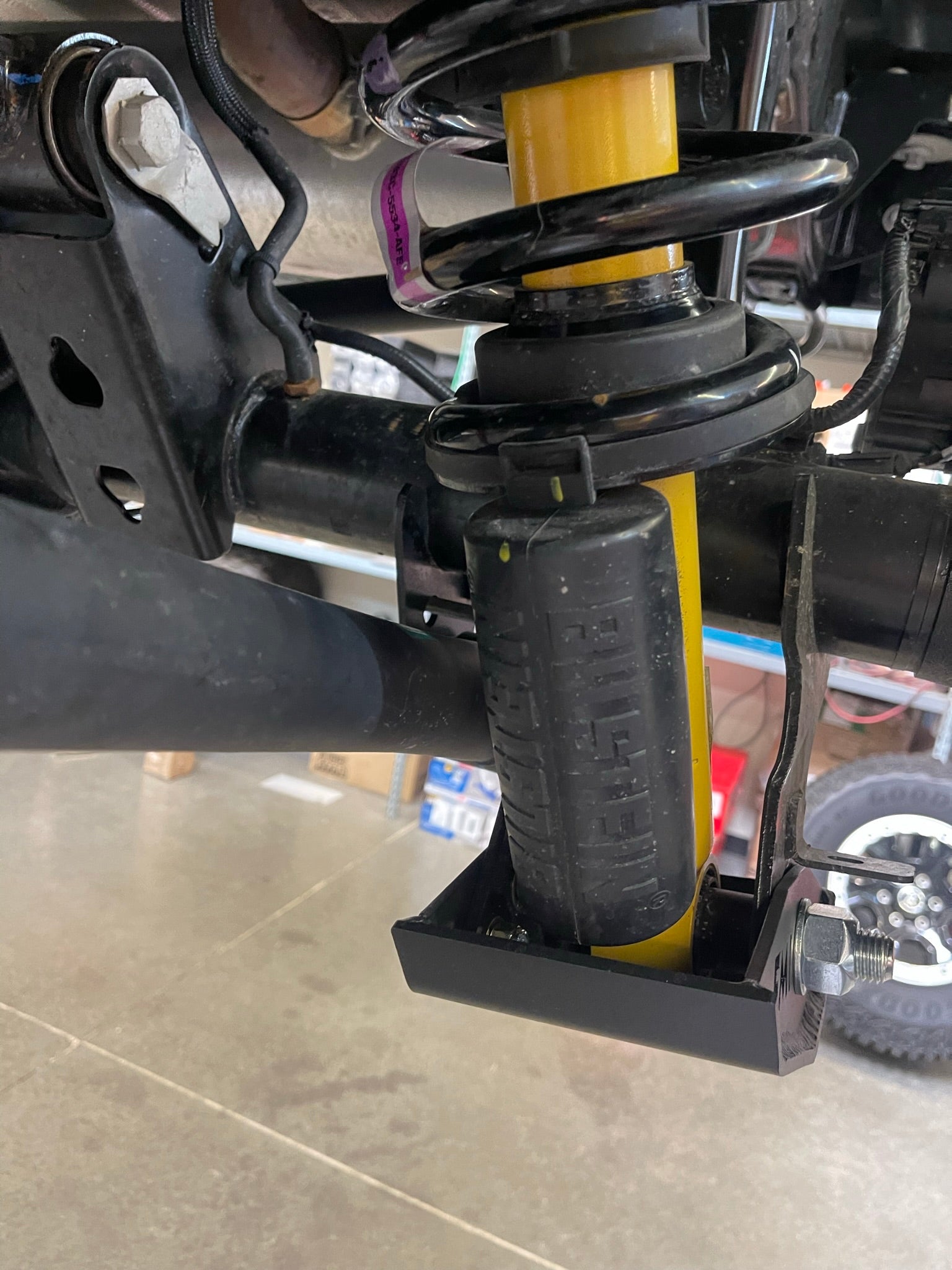 2021+ Bronco rear shock skid kit installed, featuring durable protection for Squatch and Base shocks.