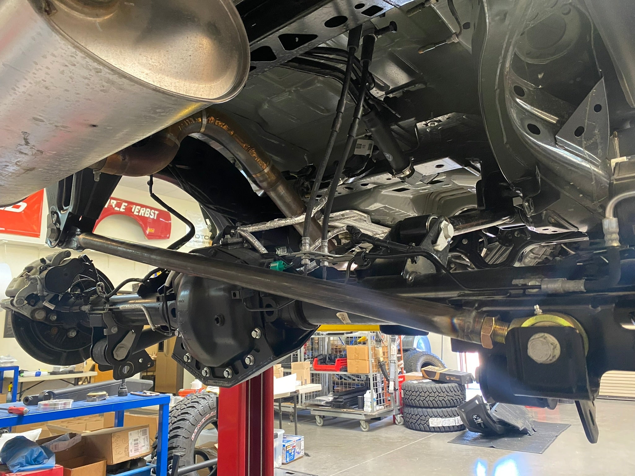Adjustable Panhard bar kit for 2021 and newer Bronco, featuring Johnny Joint design, installed under vehicle.