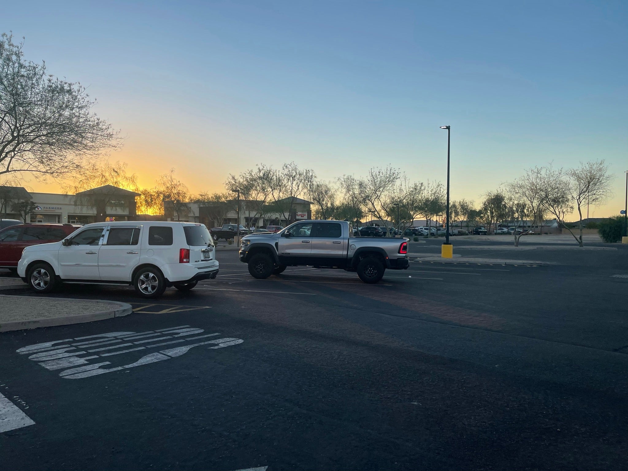 2025 Ram RHO 1.5 inch front leveling kit installed on a truck parked in a lot during sunset.