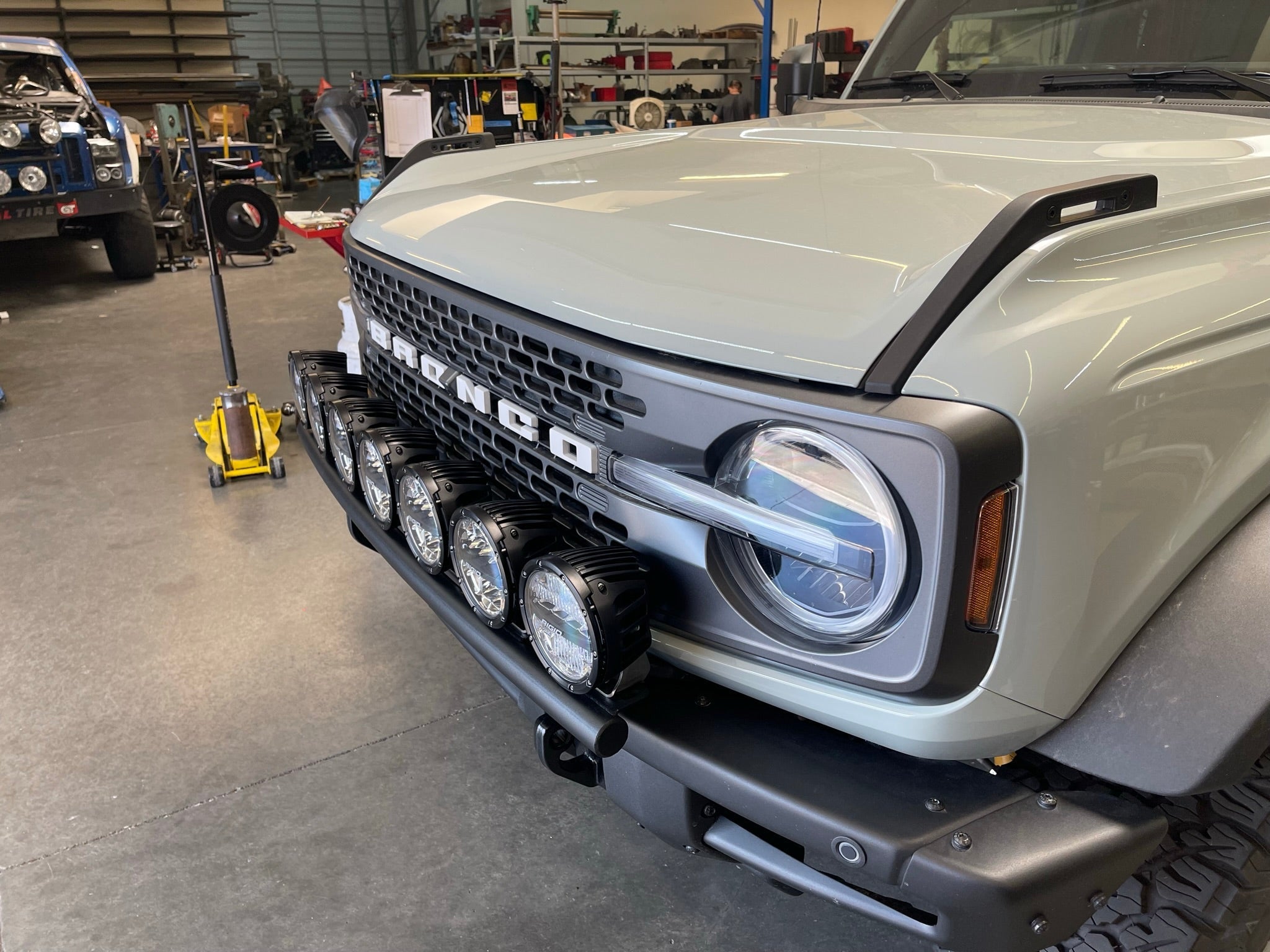 Front light mount kit for 2022-UP Bronco Raptor, showcasing multiple light options installed on the vehicle's grille.
