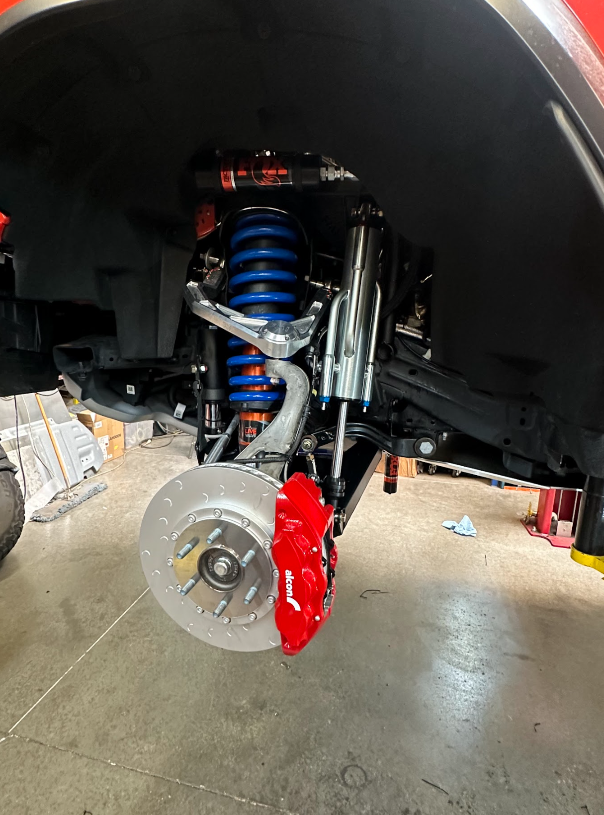 2022 Bronco Raptor mid travel front suspension kit showcasing upgraded components, including shocks and brake calipers.