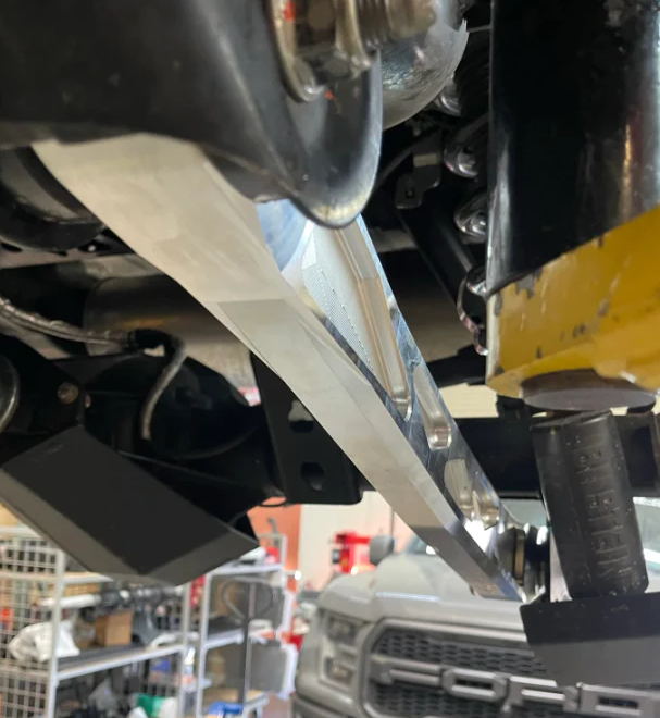 2024 Ranger Raptor rear suspension kit featuring billet aluminum arms and ultra-flex joints installed in a vehicle.