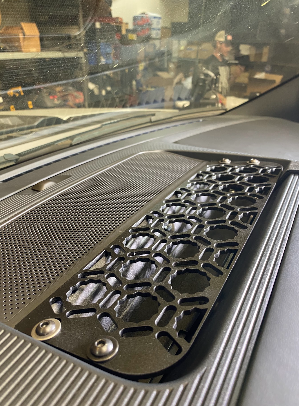 2024 F150 Raptor center dash mount kit by Adapt-A-Panel showcasing a textured black panel with hexagonal cutouts.