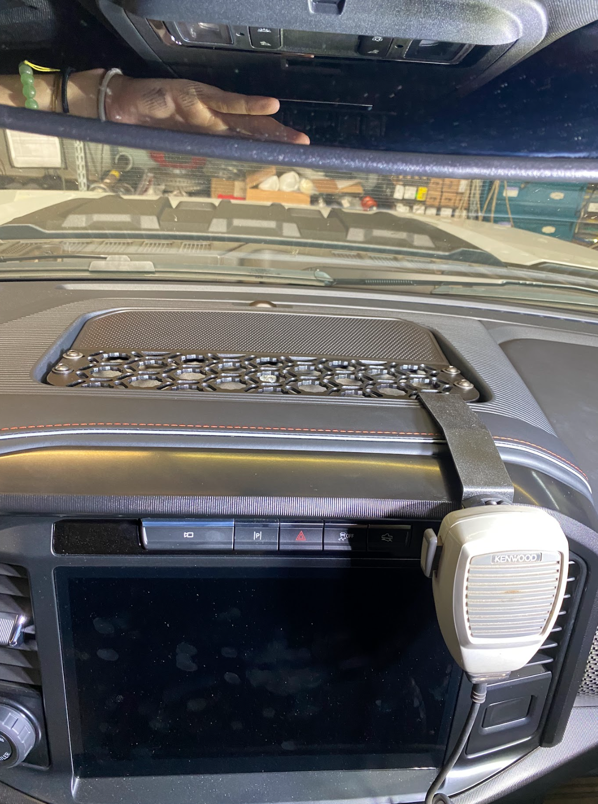 2024 F150 Raptor center dash mount kit by Adapt-A-Panel installed, featuring a textured surface and mounted communication device.