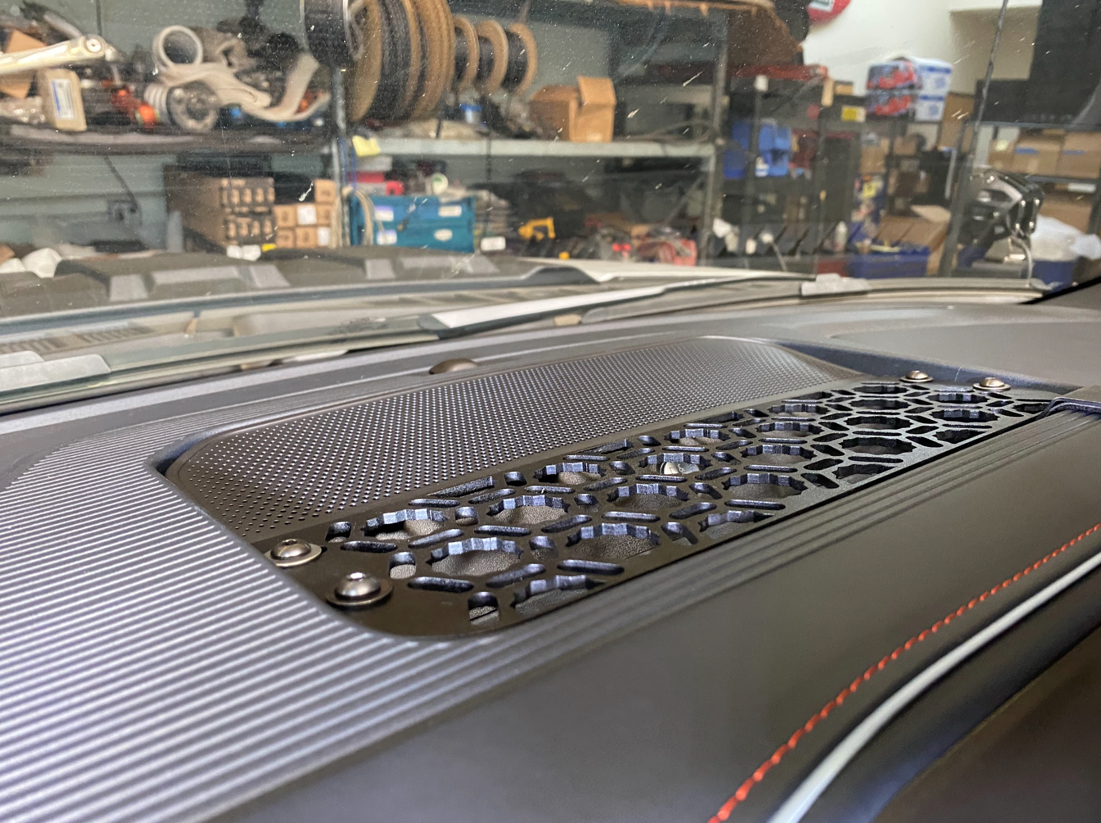 2024 F150 Raptor center dash mount kit by Adapt-A-Panel showcasing a textured surface and honeycomb design for enhanced functionality.