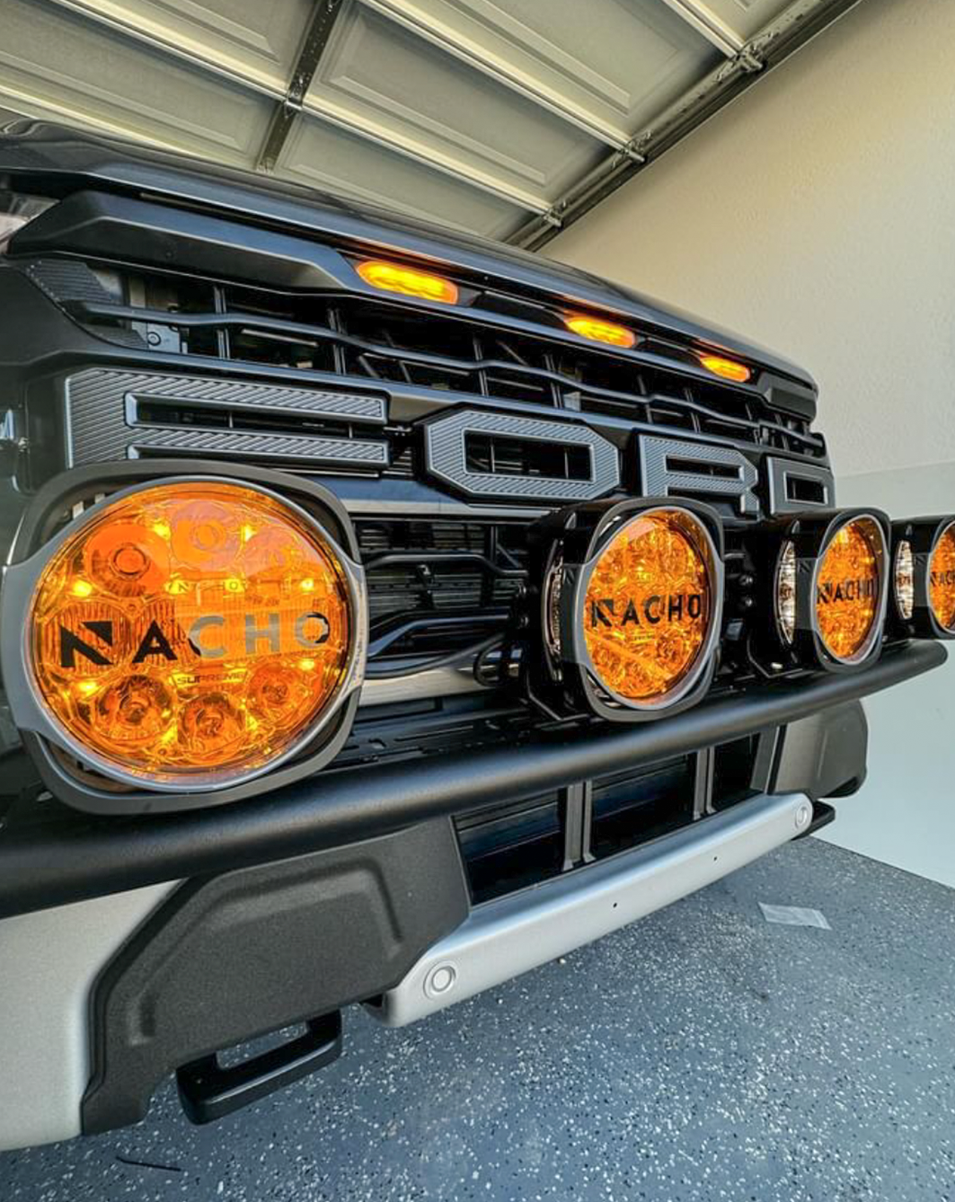 2024 Raptor Front Light Mount Kit showcasing modular bumper with multiple round lights mounted for enhanced visibility.