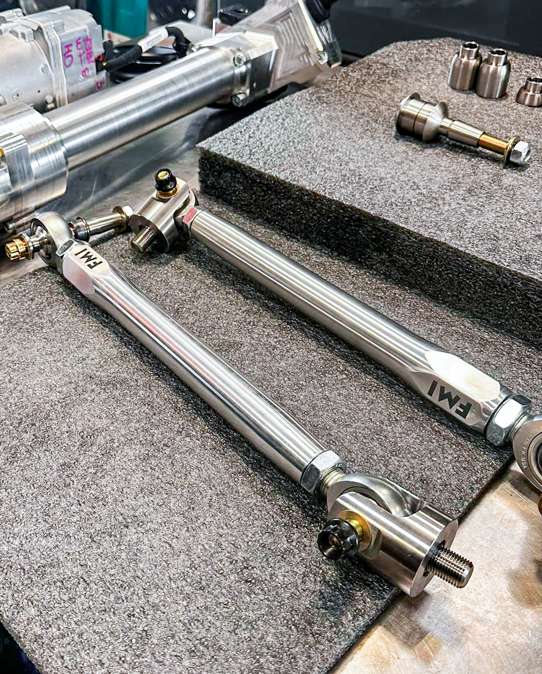 2024 Ranger Raptor Billet Tie Rod Kit displayed on a workbench, showcasing its durable construction and precision components.