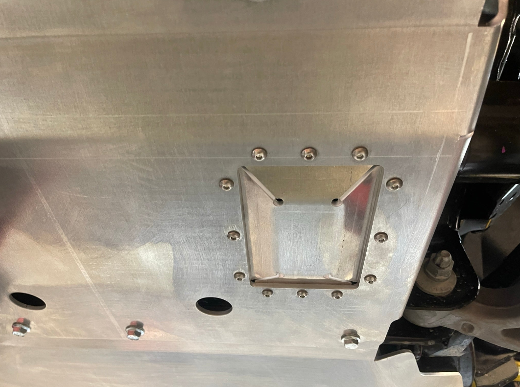 2024 Ford Ranger Raptor skid plate featuring durable metal construction and reinforced mounting points for offroad protection.