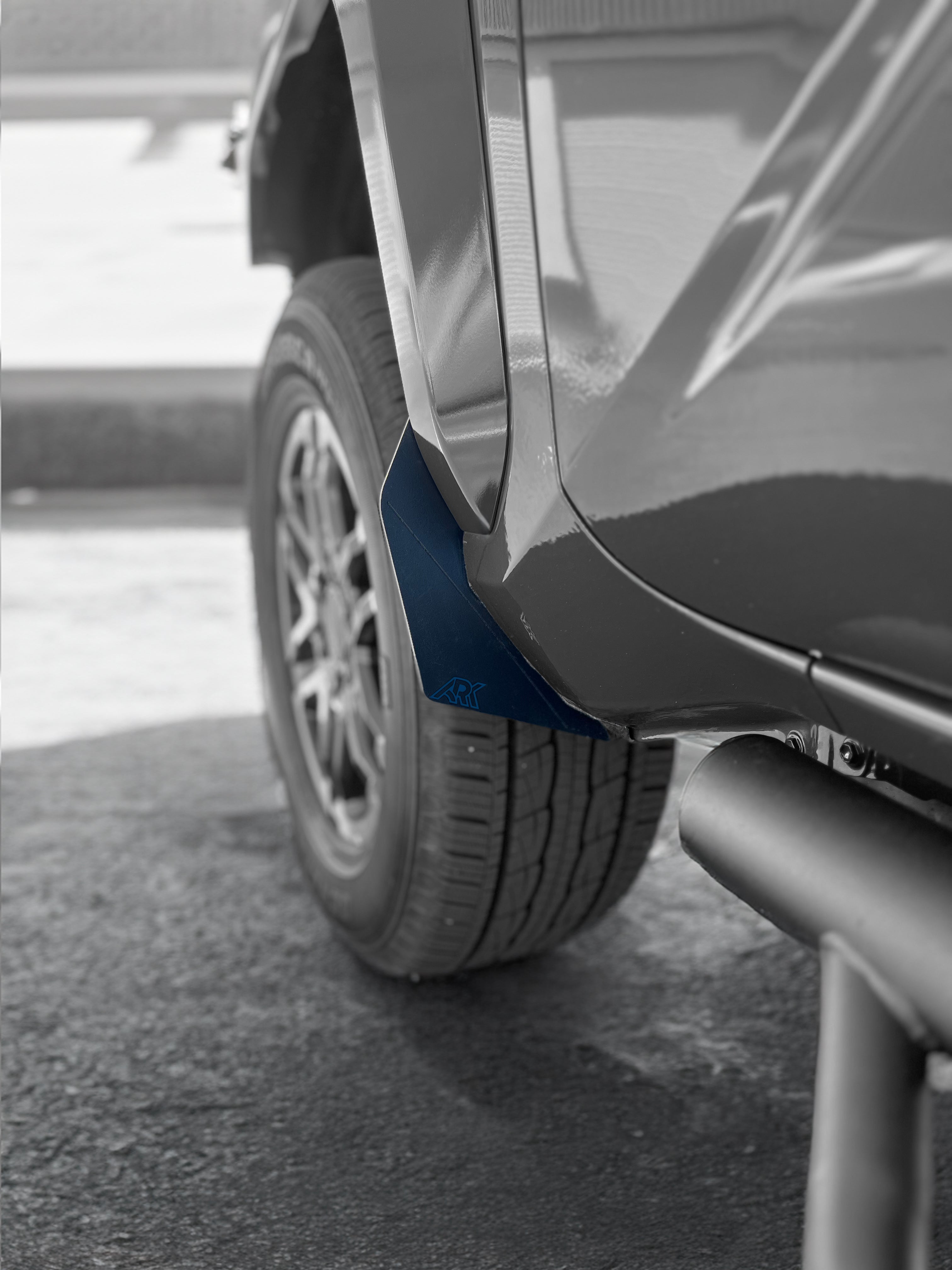 2024+ Toyota Tacoma TriXpoly splash guards and mudflap micros installed on a vehicle, providing protection from mud and debris.