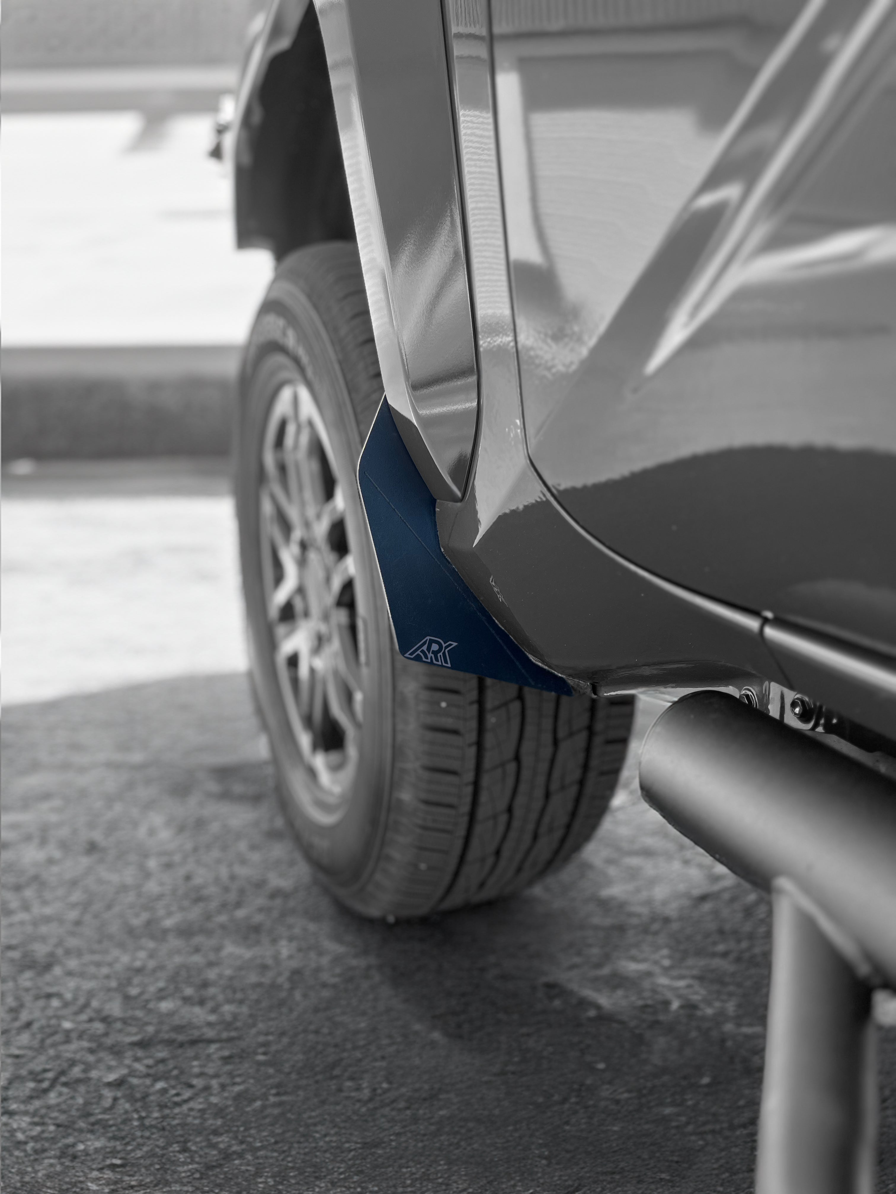 2024+ Toyota Tacoma TriXpoly splash guards and mudflap micros installed on a truck tire, providing protection from mud and debris.