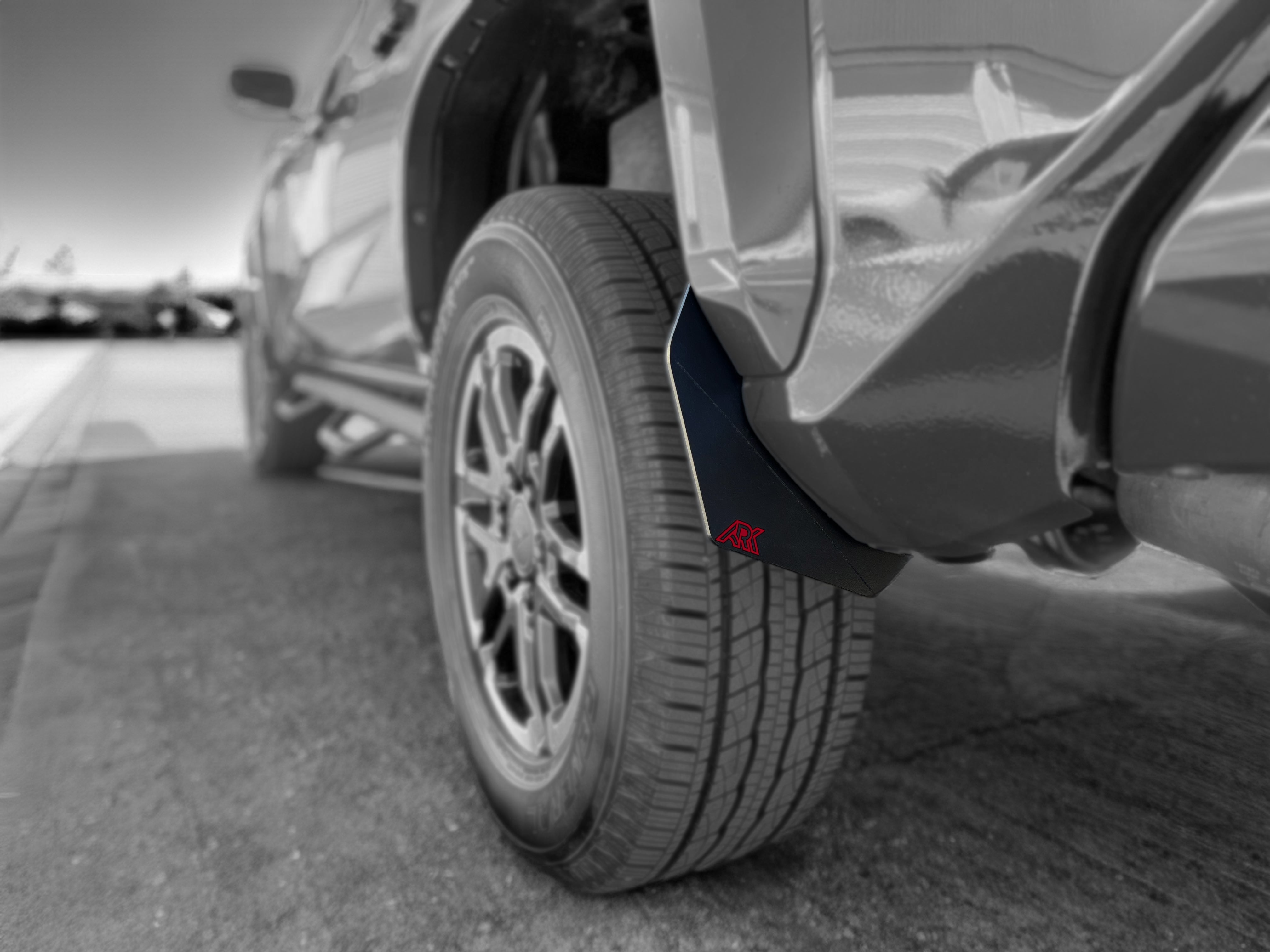 2024+ Toyota Tacoma TriXpoly splash guards and mudflap micros installed on a truck tire, providing protection from mud and debris.