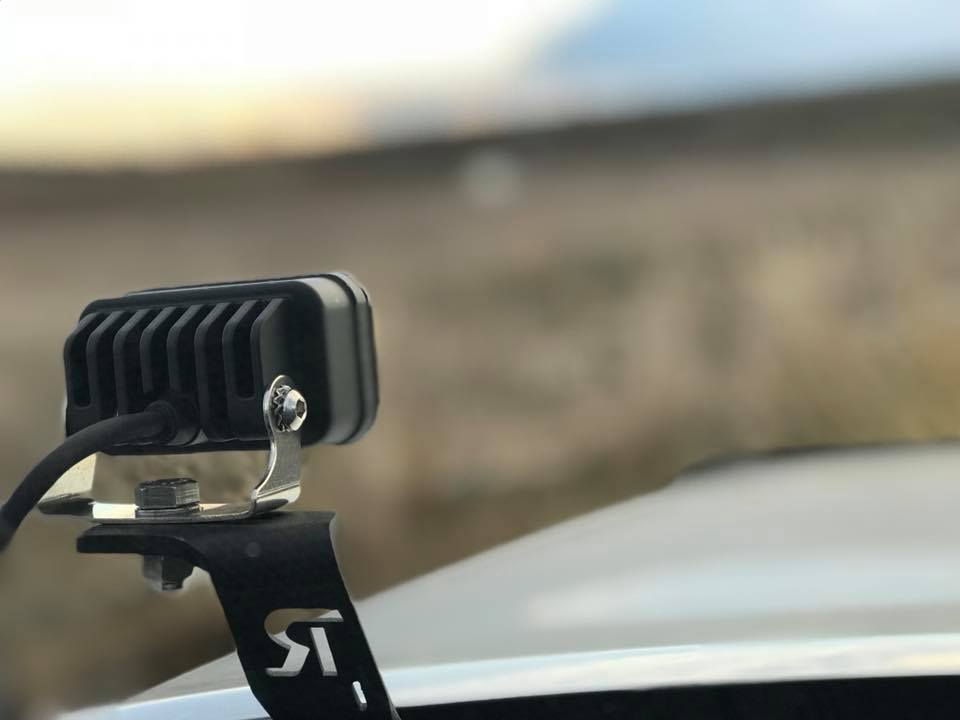 Baja Designs S2 Sport LED lights mounted on a vehicle, designed for driving and combo use in amber color.