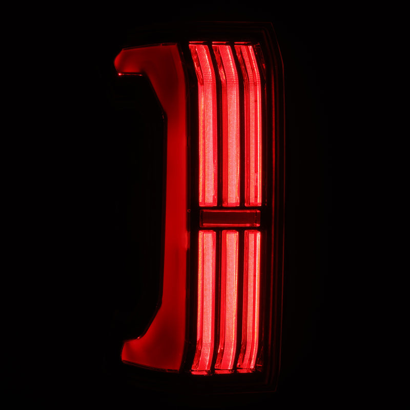 AlphaRex NOVA-Series LED prismatic tail light for 24-25 Toyota Tacoma in black, showcasing bright red illumination.