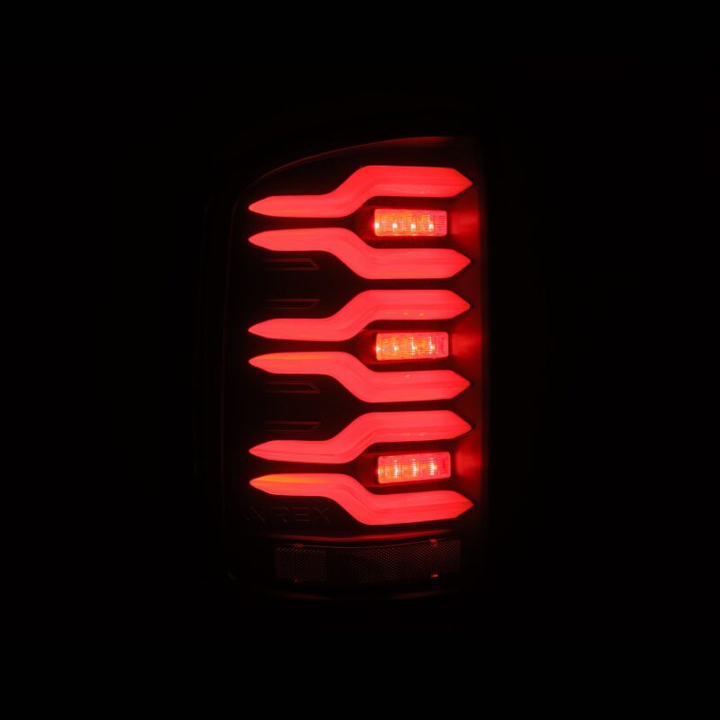 AlphaRex LUXX-Series LED tail lights for 14-18 GMC Sierra, featuring black housing, active lighting, and sequential signals.