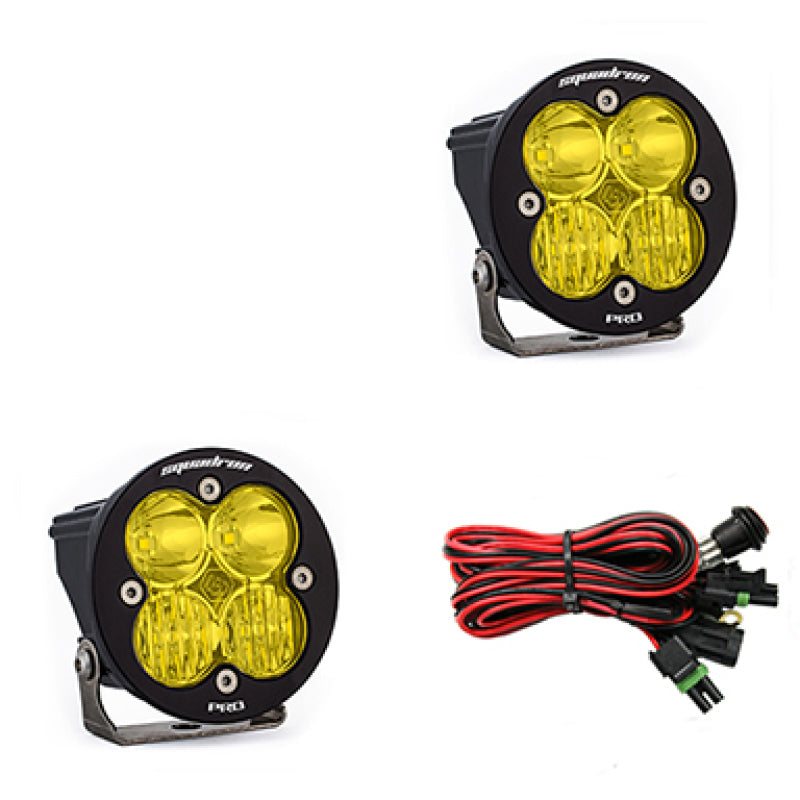 Baja Designs Squadron R Pro amber LED light pods with mounting brackets and wiring harness for offroad vehicles.
