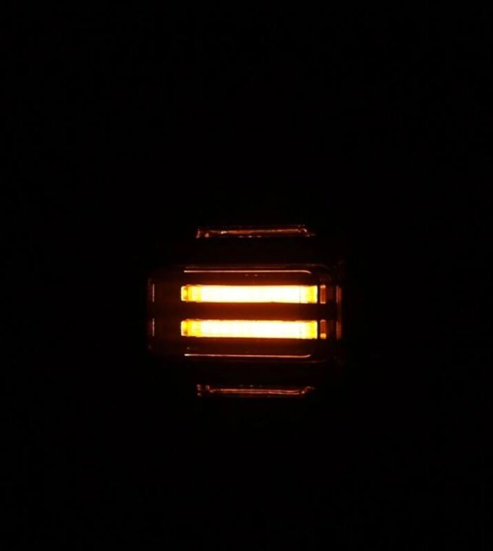 AlphaRex NOVA LED tail lights for 21-24 Ford Bronco in Alpha-Black, showcasing bright orange illumination.