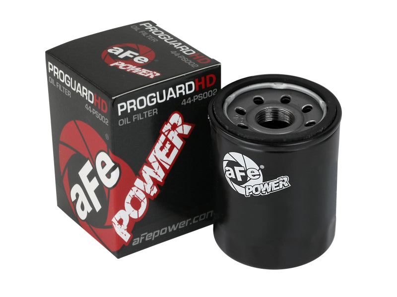 aFe PROGUARD oil filter with a black cylindrical design next to its packaging, designed for optimal engine protection.