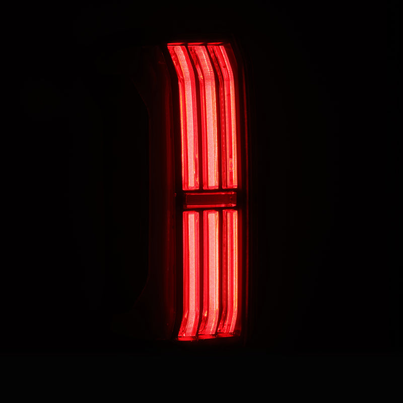 AlphaRex NOVA-Series LED prismatic tail lights for 24-25 Toyota Tacoma in alpha-black, showcasing bright red illumination.
