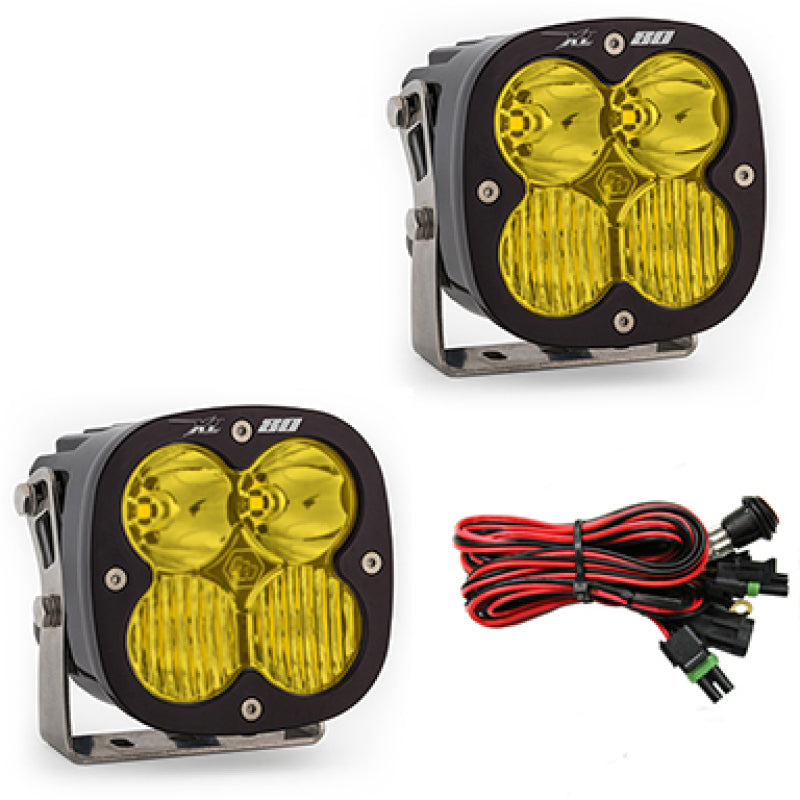 Baja Designs XL80 Series amber LED light pods with driving combo pattern, featuring a durable design and wiring harness.