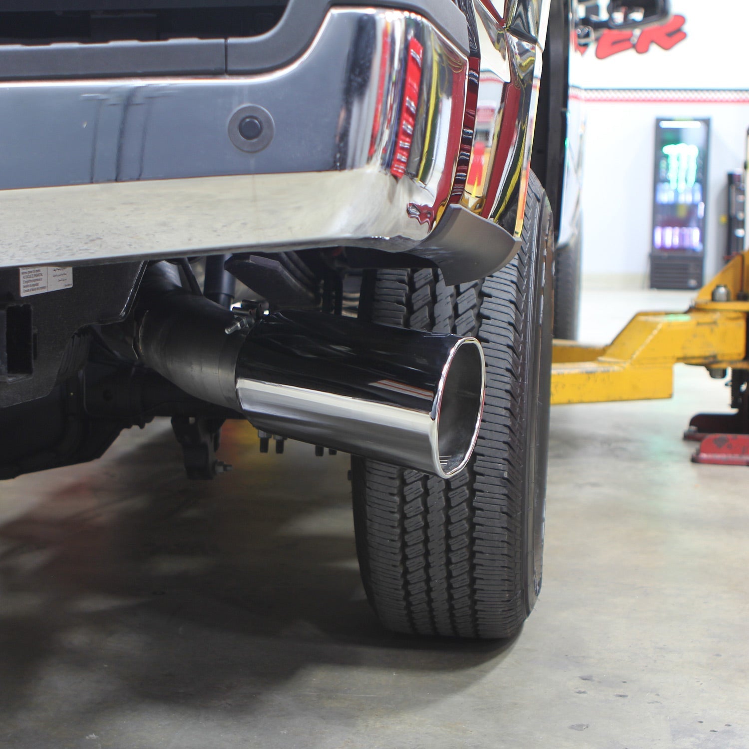 BANKS Monster Exhaust System with 5-inch single exit tip installed on a Ford F250, showcasing chrome finish and side view.