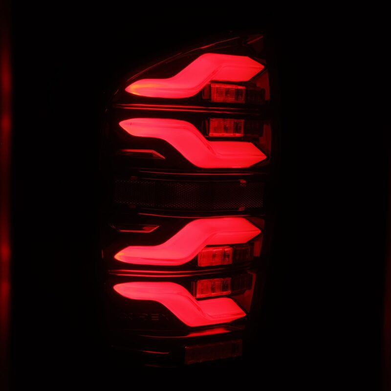 AlphaRex LUXX LED taillights for 16-21 Toyota Tacoma in black and red with sequential signal and active light features.