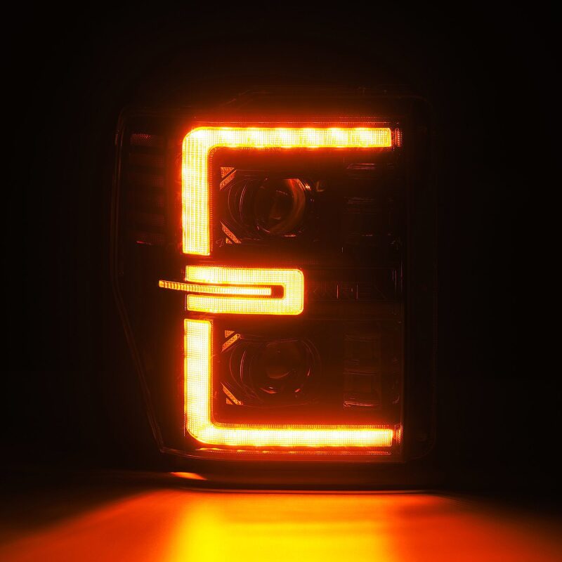 AlphaRex LUXX-Series LED projector headlights for 08-10 Ford F250-550 in black with sequential signal lighting.