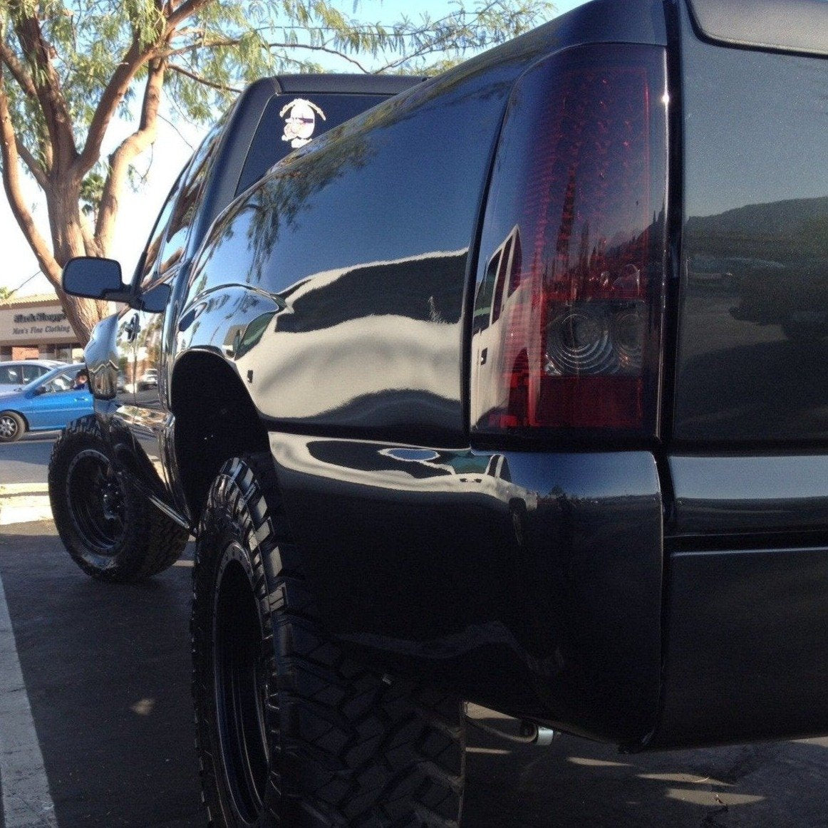 2000-2006 GMC Sierra bedsides showcasing a sleek black finish and rugged off-road tires, ideal for truck enthusiasts.