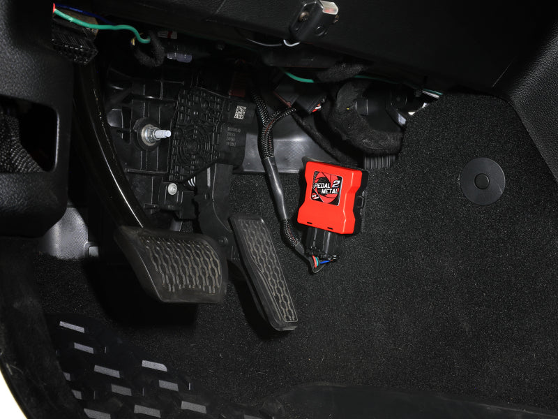aFe throttle enhancer installed in a Lexus or Toyota vehicle, showcasing the pedal area with enhanced throttle response.