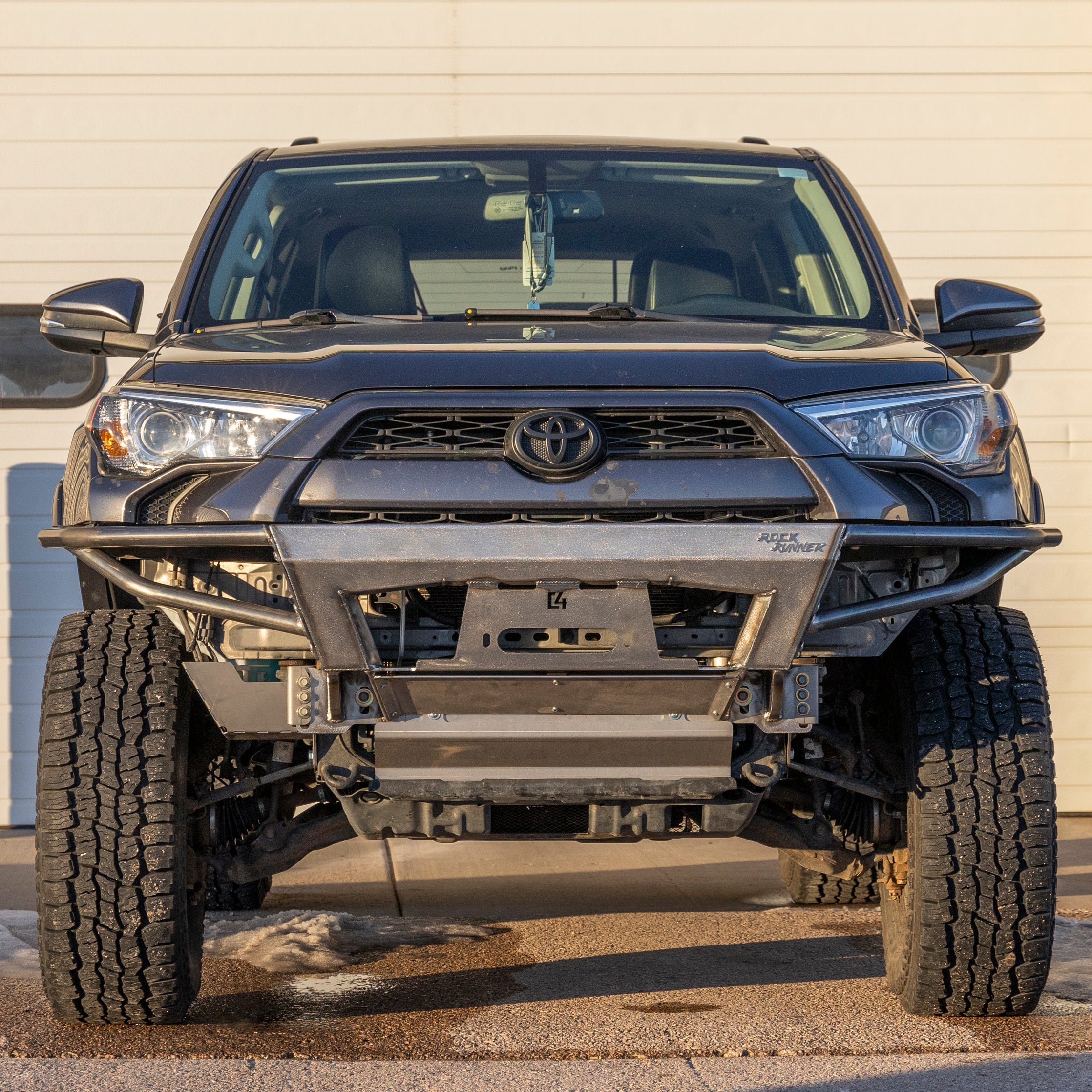 Front view of a 2010+ Toyota 4Runner with a Rock Runner front bumper, showcasing a rugged design for off-road use.
