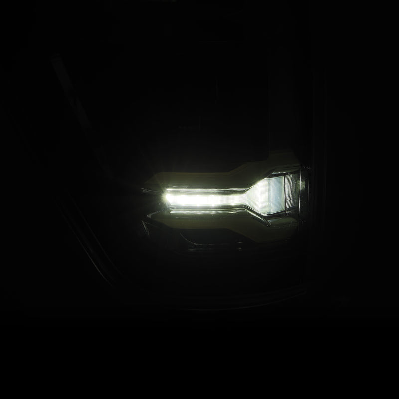 AlphaRex 21-23 Ford F-150 LUXX LED taillight in Alpha-Black with BLIS feature, showcasing bright LED illumination.