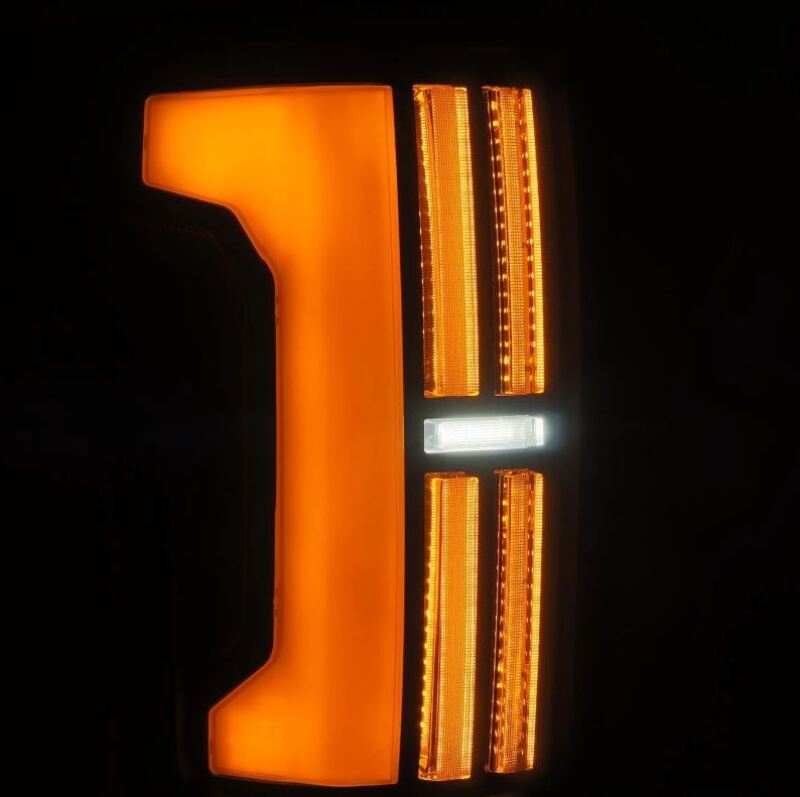 AlphaRex Nova-Series LED tail lights for 2007-2013 Toyota Tundra in black, featuring bright orange and white illumination.