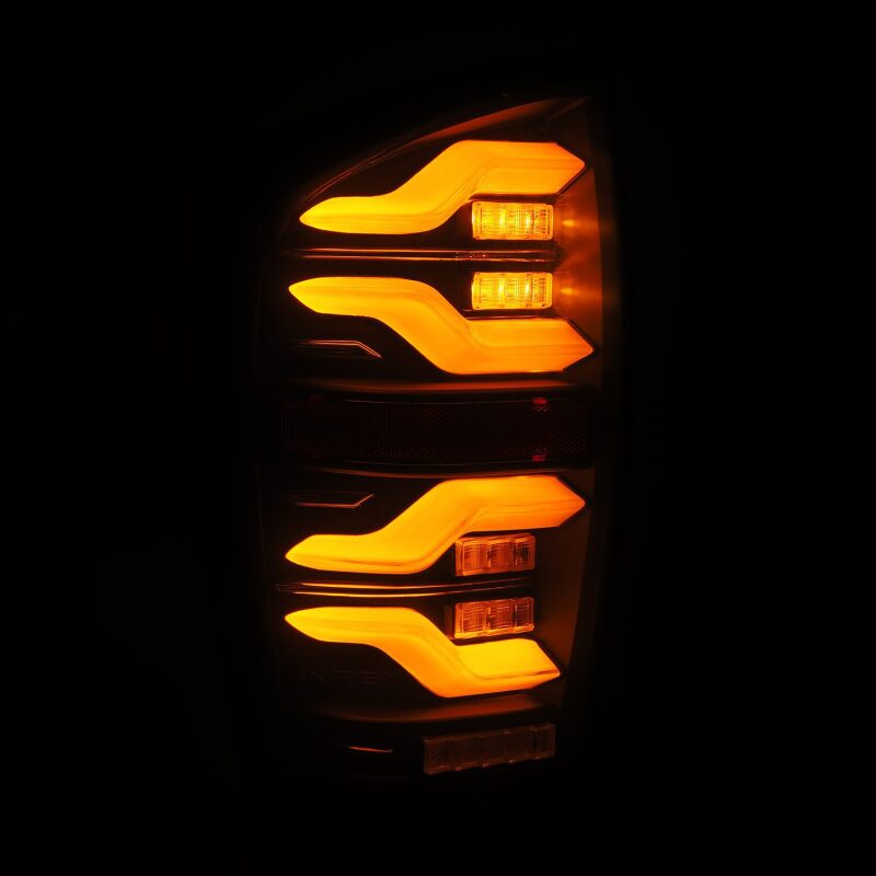 AlphaRex LUXX LED taillights for 2016-2021 Toyota Tacoma in black with sequential signal and active light features.
