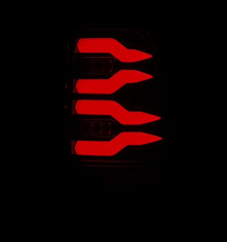 AlphaRex LUXX-Series LED tail lights for 97-03 Ford F150 and 99-16 Ford Super Duty in alpha-black finish, glowing red.