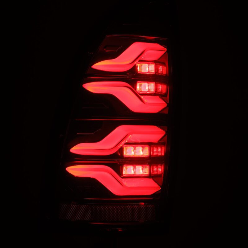 AlphaRex LUXX LED taillights for 05-15 Toyota Tacoma in black with sequential signal and active light features.