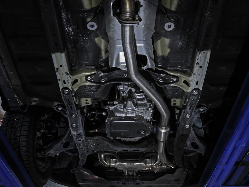 Underneath view of a Subaru Outback showing the aFe POWER Direct Fit Catalytic Converter installation for 2013-2016 H4-2.5L models.
